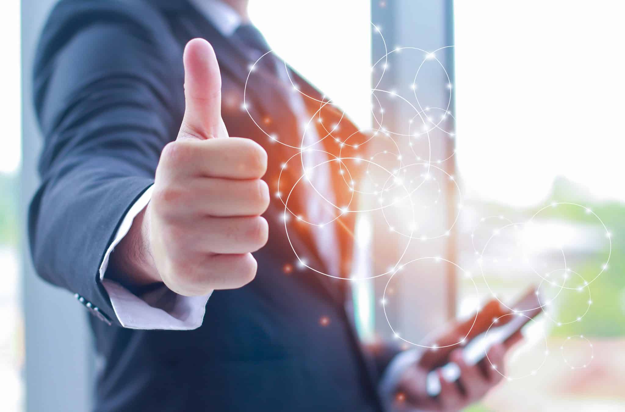 vecteezy_businessman-showing-thumbs-up-telecommunication-connection_3114974 usinessman showing thumbs up and holding a smartphone communication telecommunication connection